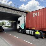 Vrachtwagen klem onder spoorviaduct Maaseikerweg